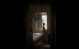 A docent in a bedroom at the Huynh Thuy Le House, a late19th-century structure in Sa Dec, made famous by its connection to best-selling French novelist Marguerite Duras.