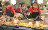 Cooks at the Shilin Night Market, Taipei's largest such market. Surgical masks are a common sight in Taipei, worn by commuters and food service workers alike.