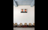 Portraits of Kim Il Sung and Kim Jong Il hang in the waiting room at the Tumangang train station.