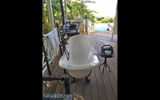 At each cottage, the bathroom is outside on a covered side deck with a privacy hedge of tall palm fronds to block the view from the neighboring cottage. The clawfoot porcelain tub is open to the elements. The loo does have a shutter door, as does the shower. Two vanities with lighted mirrors flank the tub.