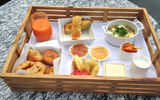 A breakfast tray delivered by room service, dubbed Rolling Mango, featured garden eggplant and pepper frittata, farm bread, fruit jams, gluten-free muffins and mango juice.