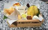 The lunch tray at Belle Mont Farm featured carambola fruit, farm bread, a coconut bar, chocolate peanut mint, banana dip, guacamole, goat cheese, lamb stew and vegetarian empanadas.