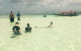 Visitors relax on one of the shallow sandbar ''swimming pools'' that are dotted among the islands.