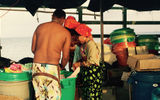 Corbisky Island women look through a barrel of clothing brought in by a ship from Colombia.