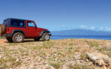 Visitors will find only 30 miles of paved road on Lanai, and the only rental vehicles available are four-wheel-drive jeeps, allowing travelers to explore an array of secluded coastlines that often showcase stunning views of neighbor islands, such as Molokai seen here.
