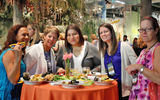 Enjoying paella at GTM's opening reception are, from left: Marilyn Mitchell, American Express; Sharon Bernhardt, Westside International Travel at Altour; Elizabeth Diaz, Super Value Tours; Tara Schreiner, Super Value Tours; and Karen Bauer, Interliner.com. The reception, held at the Fort Lauderdale Museum of Discovery & Science, was sponsored by the Greater Fort Lauderdale Convention & Visitors Bureau.