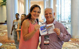 Maribel Maldonado from the Mexico Tourism Board and Hugh Sheppard from Encore Travel participate in the event's Meet your Match contest, sponsored by Passport Online's ESP program. All attendees were challenged to find the individual who had the matching half of their travel image.