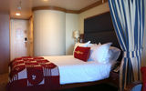 A stateroom in Category 04A, Deck 9, featured a queen bed, pullout couch, desk and balcony.