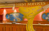 Taking the "wraps" off the signage behind the guest services desk.