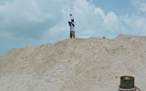 A worker tests the quality of a pile of sand on Castaway Cay.