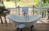 The guest cottages at the Kittitian Hill resort community on St. Kitts feature an open-air bathroom with a claw foot porcelain tub on the outside deck.