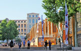 The M Pavilion, at right, a temporary building providing tourist assistance, including information and booking services associated with Marseille's year (2013) as Europe's culture capital. The InterContinental Marseille-Hotel Dieu is visible in the background.