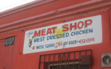 A sign above a doorway in Falmouth, Jamaica, advertising the wares inside