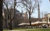 An outdoor cafe in the outermost courtyard at Topkapi Palace, with the Hagia Sophia visible in the background. This courtyard is open at no charge to the public and functions much like a park.