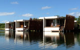 The largest accommodations are the 18 overwater suites that float out over the water's edge where the lagoon widens out.