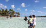 Walking from the boat to the island through shallow water.