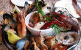 The "Grand Plateaux de Fruits de Mer" at oyster bar Dickie Brennan's Bourbon House, heaped with oysters, Cajun caviar, Gulf shrimp, mussels, clams, crab and seafood salad.