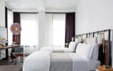 The Garment District's Refinery Hotel features 197 rooms with exposed beams and 12-foot ceilings and railroad-tiled bathrooms.