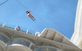 One of the first users to experience the Zip Line ride on the Oasis of the Seas, as seen from the Boardwalk.