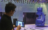 Saverio Panata, project manager for Makr Shakr, the company behind Quantum of the Seas' bionic bartenders, demonstrates how customers enter drink orders on a tablet.