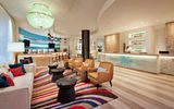 The Best Western Premier, the first full-service, Haitian-owned, U.S.-branded hotel to open in Haiti serves as a showcase for the country's art. The hotel's lobby offers a modern, welcoming reception area with spacious seating and a bar area.