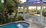 Each beachfront villa has a private plunge pool and a grassy front yard.