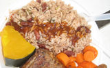 A platter of rice, peas and chicken, accompanied by yams and plantains, is a typical meal served in local restaurants in St. Kitts and Nevis.