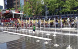 During the warm weather, kids splashed in street fountains that spouted geysers of water. TW photo by Gay Nagle Myers