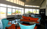 Exclusivity's expansive main room has three sitting areas and views of the ocean. The sound system pipes music throughout the villa and onto the pool deck.