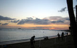 Sunset on Waikiki Beach is a special time of the day: People gather on the sand to watch the sun dip below the waterline.