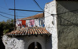 In Kruja, tile-roofed, white plaster houses with their signs of life: laundry on the line and a chaos of electrical wires.