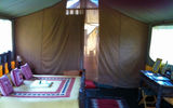 The spacious, eco-friendly interior of a two-bed, three-person tent at Gamewatchers Safaris' Porini Mara Camp.