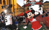 Garrett Hartley, place-kicker for the Super Bowl XLIV champion New Orleans Saints, kicks a football Feb. 25, 2010 over the entrance archway to the newly rebranded ESPN Wide World of Sports Complex in Lake Buena Vista, Fla.