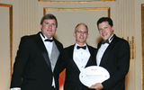 Globus President and CEO Scott Nisbet, center, with Sullivan and Weissmann after taking the Best in Europe prize for the fifth year in a row.