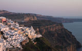 A city view that makes clear where Fira, Santorini's capital, is situated -- at the top of a steep bluff. The city overlooks the water-filled caldera left by a colossal volcanic eruption in antiquity.