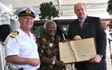 Archbishop Desmond Tutu, flanked by Captain Nick Bates and Cunard Line President Peter Shanks, commemorate the maiden call of the Queen Mary 2 in Cape Town, South Africa, on March 25.