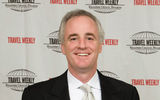 Dan Mahar, CEO of Tauck World Discovery, with Tauck's Best in Canada award. (photo by Steve Hockstein/Harvard Studio)