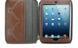 Made of 100% premium leather, the Milano Portfolio Leather Mini iPad Case from MapiCases not only protects your Mini with a zip closure on three sides, it also babies it with a fully lined fabric interior that includes two credit card slots and a pocket for other documents. While designed so that it offers complete accessibility during a flight, you'll have to remove the iPad from the case to take a photo (there is no hole for the camera).