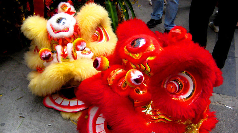Often missed by visitors, China's booming southern metropolis of Guangzhou and the more remote Zhangjiajie, in Hunan province, offer travelers a vivid combination of modern cityscapes, rich culture, and dramatic natural beauty. Pictured here, masks from a traditional lion dance celebration in the streets of Guangzhou. Unless noted, photos by Shane Nelson.