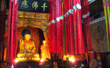 A monk burns incense at a temple in the mountains near Baofeng Lake.