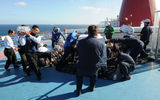 Sailors from the aircraft carrier Ronald Reagan helped Carnival Splendor crew unload food and water supplies from the Navy vessel.