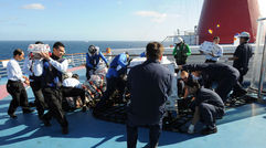 Sailors from the aircraft carrier Ronald Reagan helped Carnival Splendor crew unload food and water supplies from the Navy vessel.