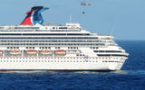 A U.S. Navy helicopter bringing supplies to the Carnival Splendor approaches the cruise ship. The Splendor was stranded southwest of San Diego after an engine-room fire.