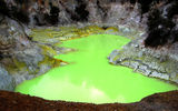 The natural green of the Devil's Bath occurs thanks to excess water from the Champagne Pool mixing with sulfur and ferrous salts. Rainfall and the availability of sunlight impact the mineral pool's green to yellow coloring.