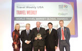 Peter Shanks, president of Cunard Line (middle) accepts a World Travel Market Global Award on behalf of the Carnival Foundation.