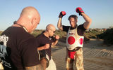 Krav maga instructor Shai Fargian (in glasses) teaches Travel Weekly Destinations Editor Kenneth Kiesnoski and his brother Jeffrey how to take a punch