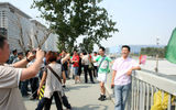 Visitors posing in front of the Beijing Olympics National Stadium and National Aquatics Center.