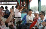 Traveling by tour boat, a group of American tourists views the Summer Palace outside of Beijing.