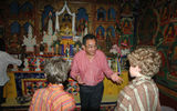 Dasho Tobgye Dorji explains the meaning of items in the shrine room of Hotel Gangtey Palace to the author's sons