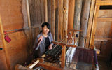 A woman weaves traditional designs at the Yatha Weaving Center near Bumthang